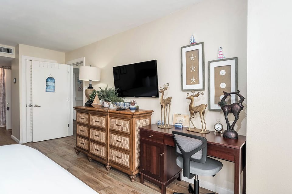 Coastal vibes meet convenience with this beachy TV nook and workspace setup.