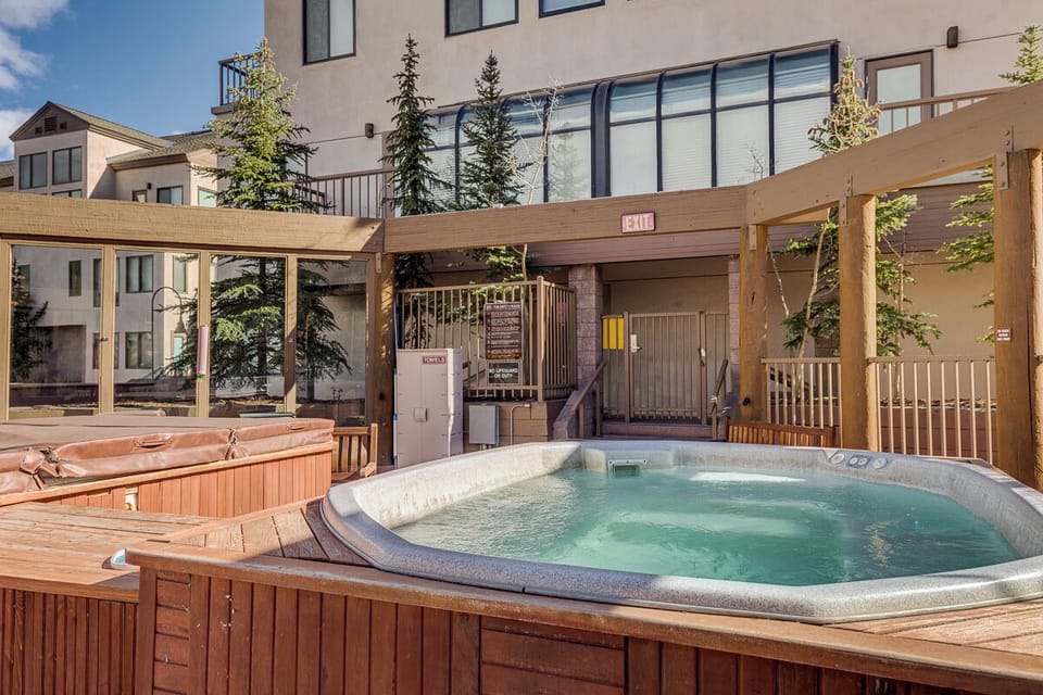 Unwind in the bubbling hot tub on your private deck, surrounded by evergreen trees and mountain charm.