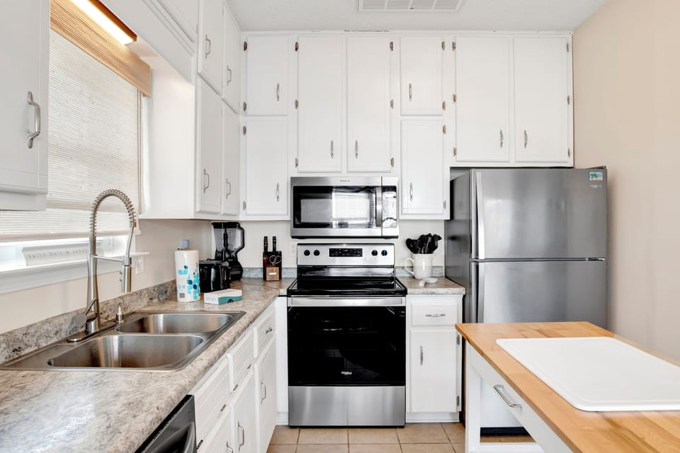 The kitchen is fully equipped and offers stainless appliances