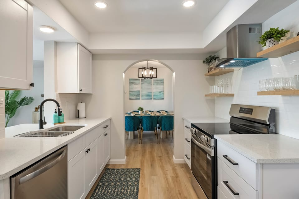 Bright, modern kitchen with open shelves, stocked for easy meals & comfort.