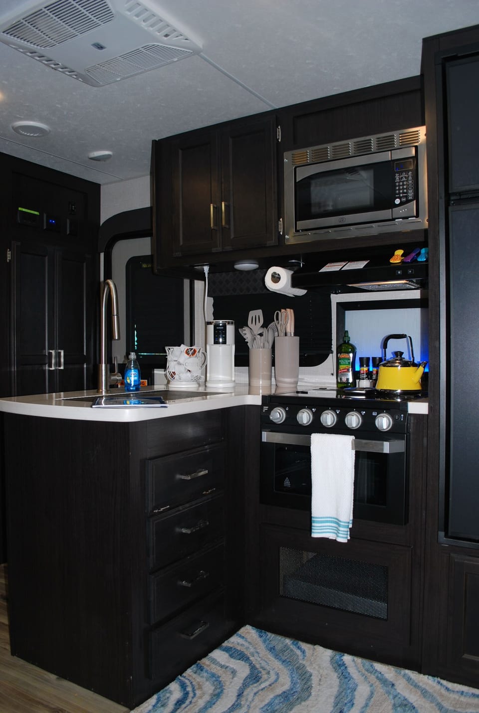 Compact kitchen: stove, fridge, microwave, Keurig & more for your cooking needs.