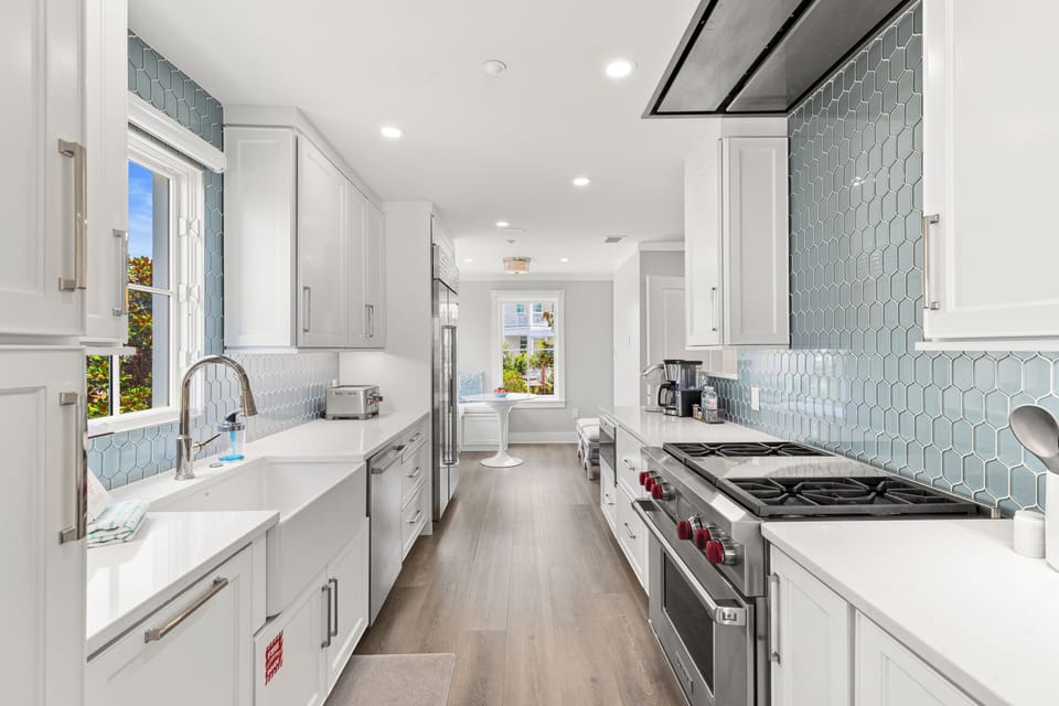 Your gourmet kitchen awaits with premium appliances, marble counters, and stunning blue tile backsplash for memorable culinary moments.