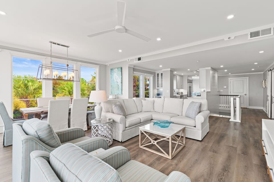 Sink into plush seating in your bright, open living space with tropical views and modern coastal style.
