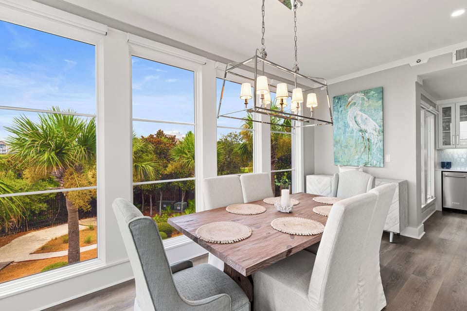 Gather around this elegant dining table where you'll enjoy meals with stunning garden views through floor-to-ceiling windows.