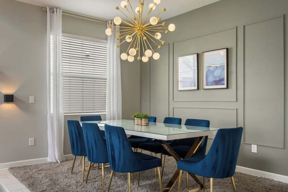 Dine in style under a stunning chandelier. This elegant space invites family meals, laughter, and special moments shared around the table.