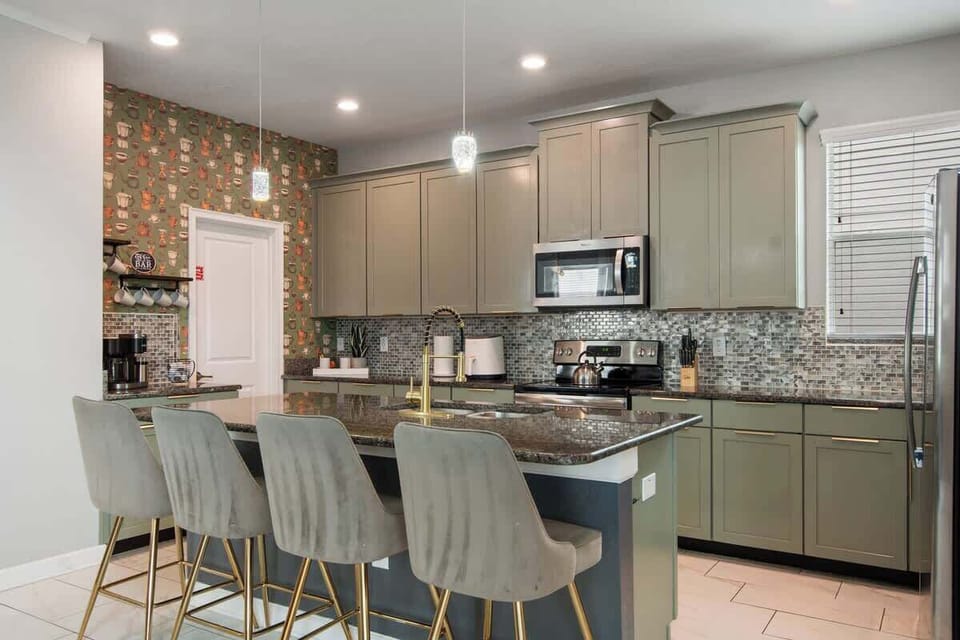 Cook, connect, and create memories in this stylish kitchen with modern appliances, granite counters, and a cozy island perfect for family breakfasts or evening wine chats.