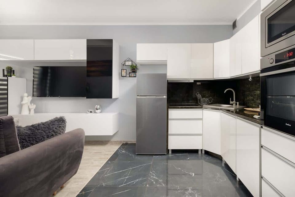 An open-plan kitchen and living area with modern finishes and neutral tones.
