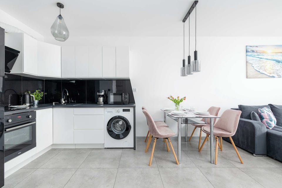 The sleek design of the kitchenette blending seamlessly with the living area.