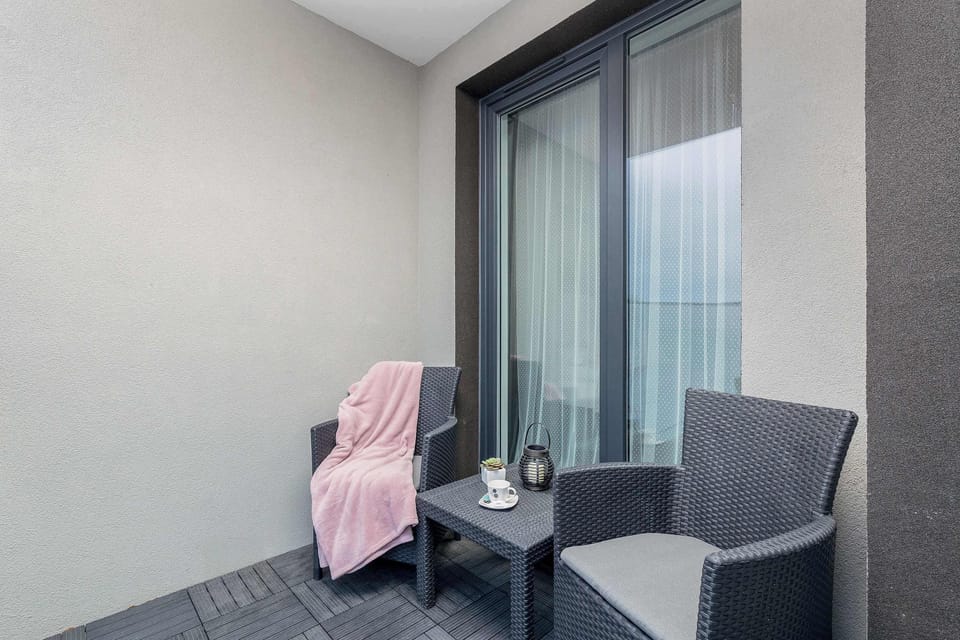 The balcony provides a tranquil spot for enjoying a book. 