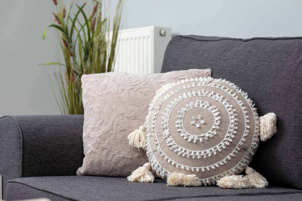 A detailed look at the sofa with decorative pillows, emphasizing comfort and style.