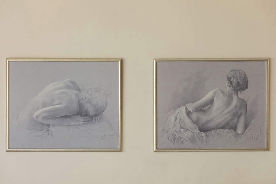 A close-up of decorative paintings in gold frames that give the room a cozy feel.