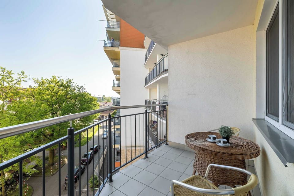 A balcony with two chairs and a table will be the perfect place to drink your morning coffee.
