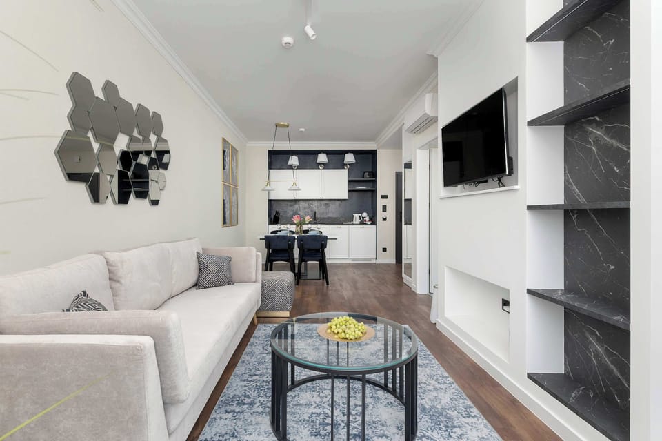 The elegant living room featuring a double sofa bed, perfect for relaxing or sleeping.