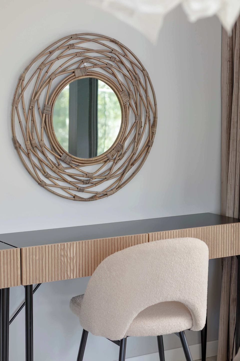 A minimalist desk in the bedroom with a comfortable chair and stylish lamp. Ideal for working or studying in a calm, private space.