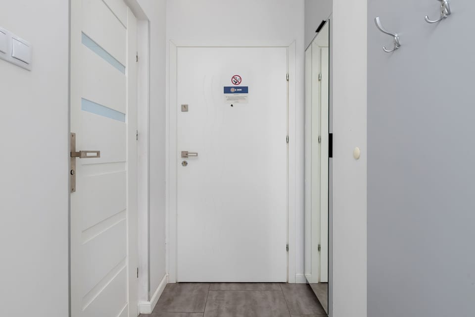 Hallway with doors leading to the main living space and bathroom.