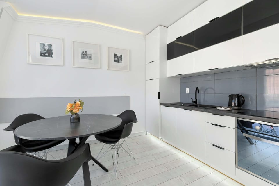 Dining area with a round table and chairs, adjacent to the kitchenette.