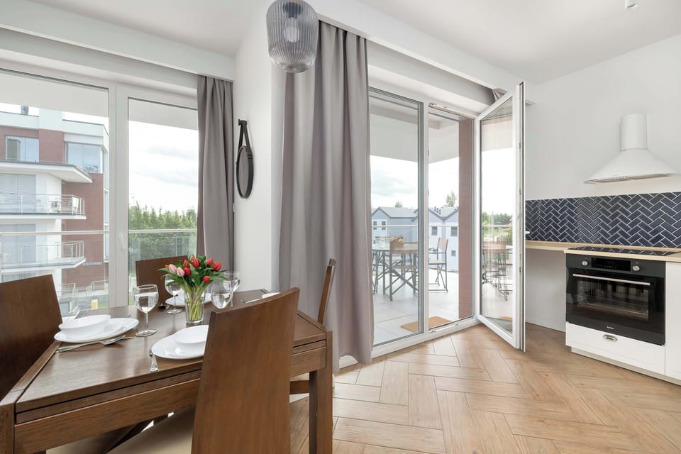 A dining living space with floor-to-ceiling windows and access to the balcony. Ideal for casual meals and morning coffee with natural light.