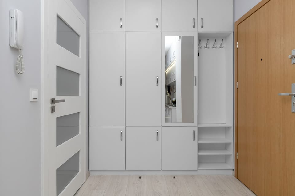 The practical hallway cabinetry provides ample storage and helps keep the space tidy.

