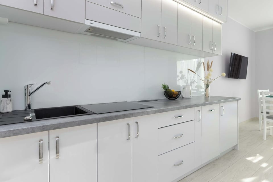 The functional kitchen with a generous countertop and full amenities makes cooking and storage effortless.