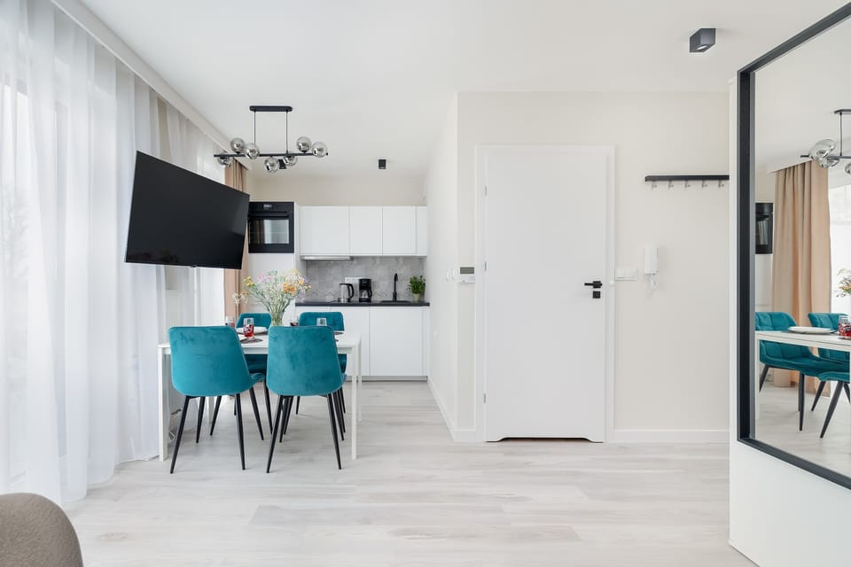 Living area with kitchenette brightened by natural light.