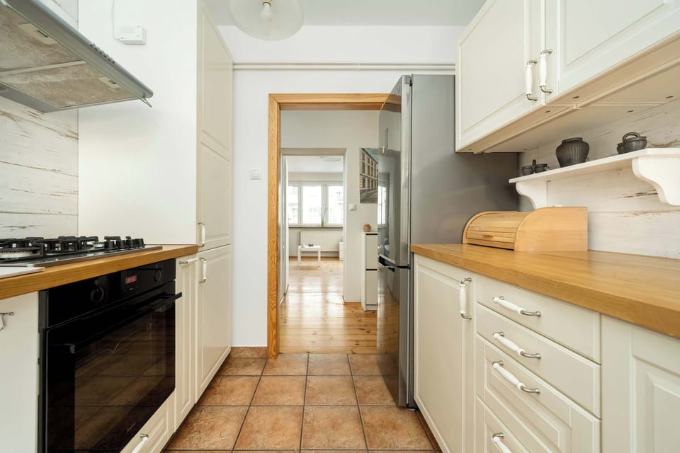A view into the kitchen showcasing a gas stove, oven, and bright interiors. The layout ensures easy meal prep.