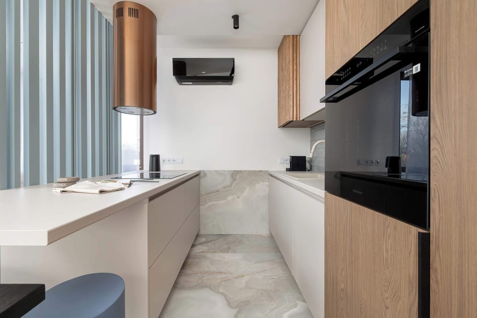 The sleek design of the kitchenette blending seamlessly with the living area.