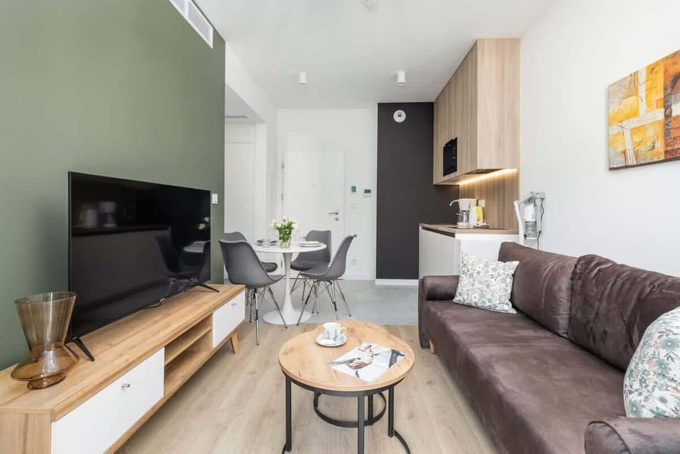 A modern entertainment unit with a large TV, sleek storage, and decorative accents in the living room.

