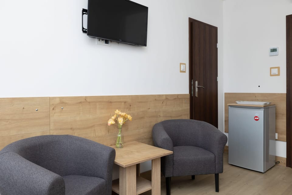 Living area with television, where the guests can relax, watching their favourite shows.
