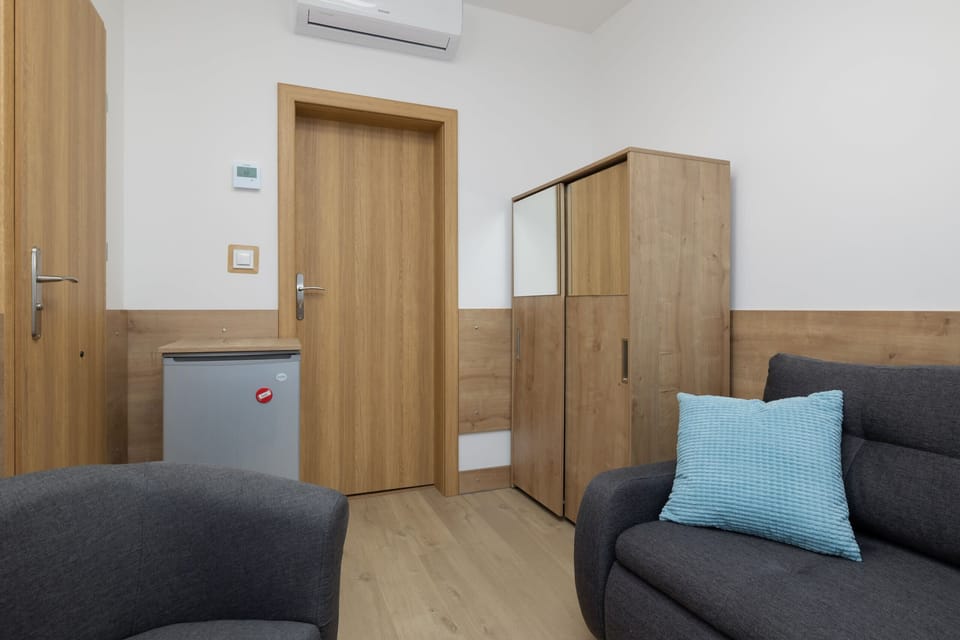 Living area with armchairs and a closet, where the guests can store their clothes.