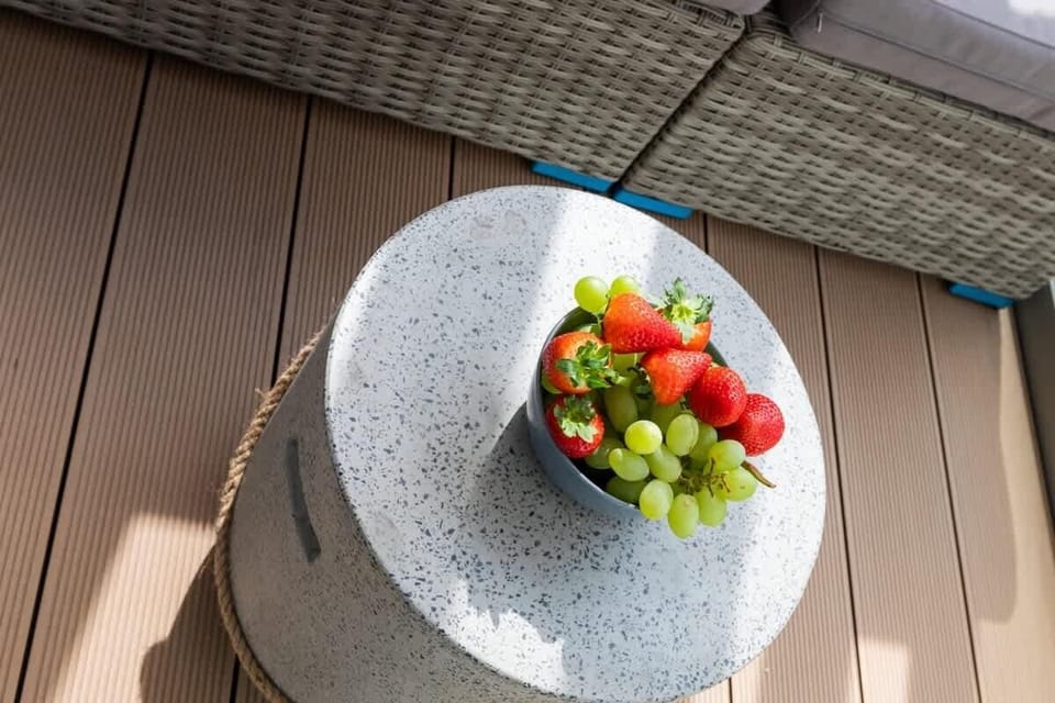 A detailed look at a table on the balcony with a colorful bowl of fruit, adding a vibrant touch.