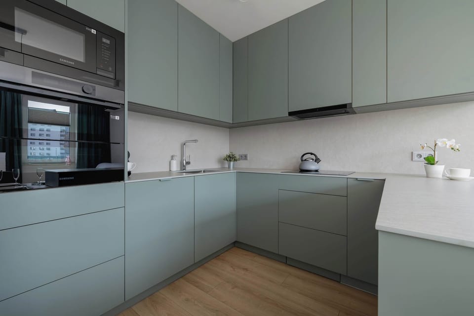 A minimalist and modern kitchen with ample counter space and built-in appliances. The clean design enhances both style and efficiency.