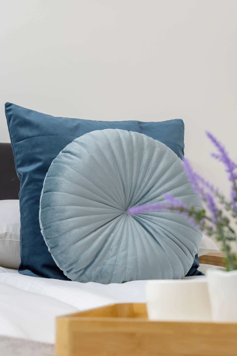 A close-up of the stylish bedroom decor with plush cushions and soft tones. The neutral colors create a calming atmosphere.