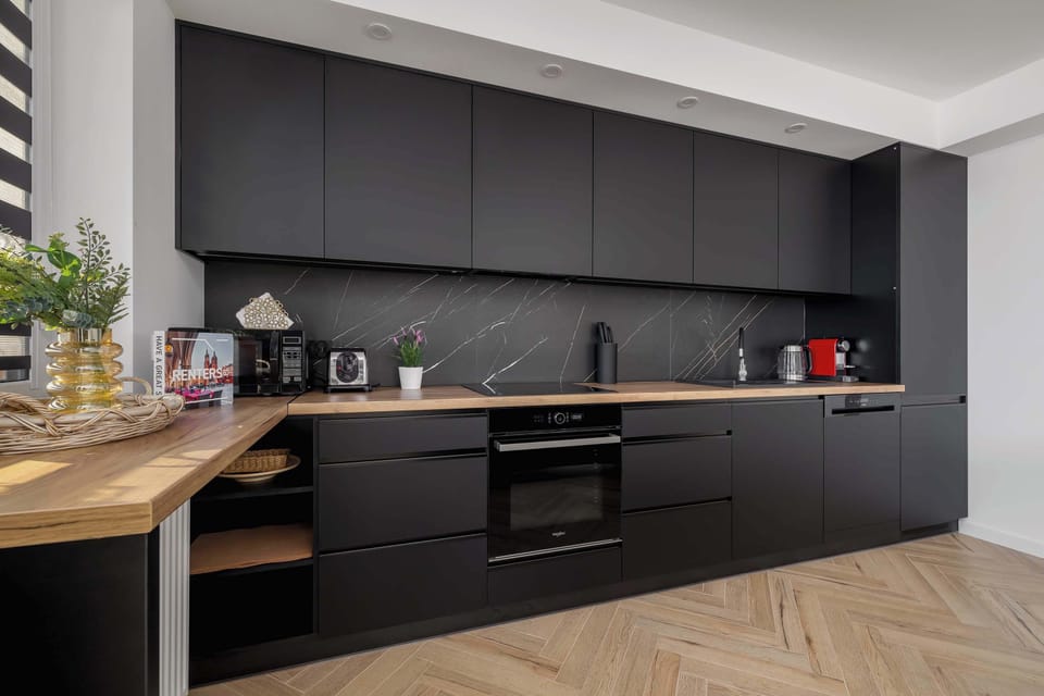 The sleek design of the kitchenette blending seamlessly with the living area.