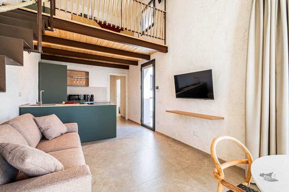 Welcoming living space with a comfy sofa bed, TV, and direct access to the patio.