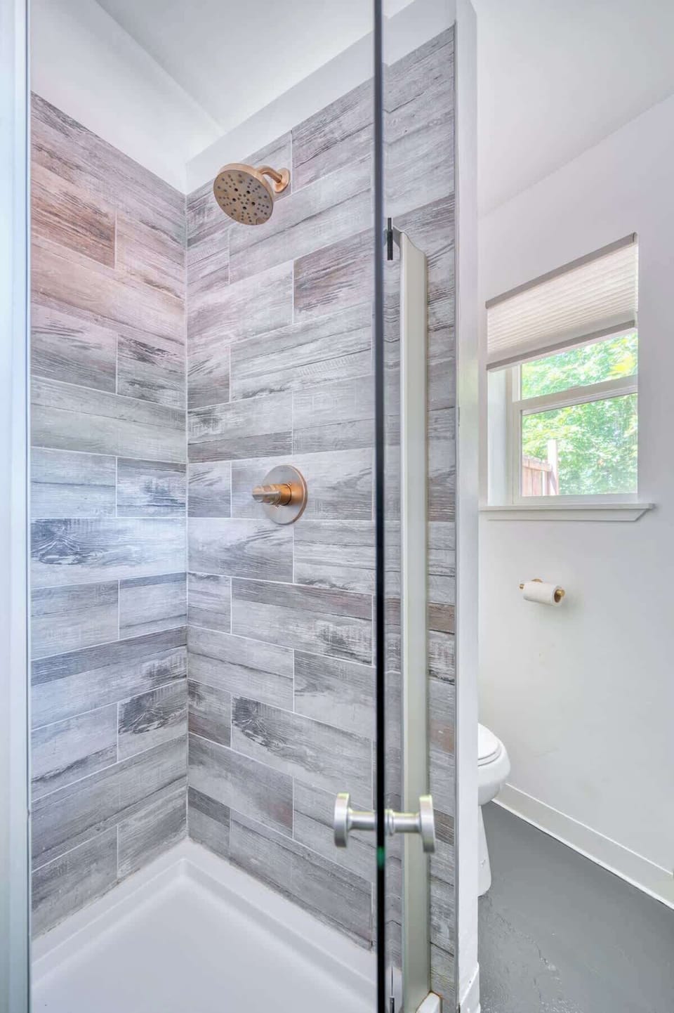 Tiled shower with a glass door and a shower tray.