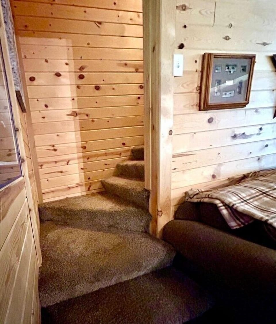 Stairs leading to three private bedrooms and an additional full bathroom. 