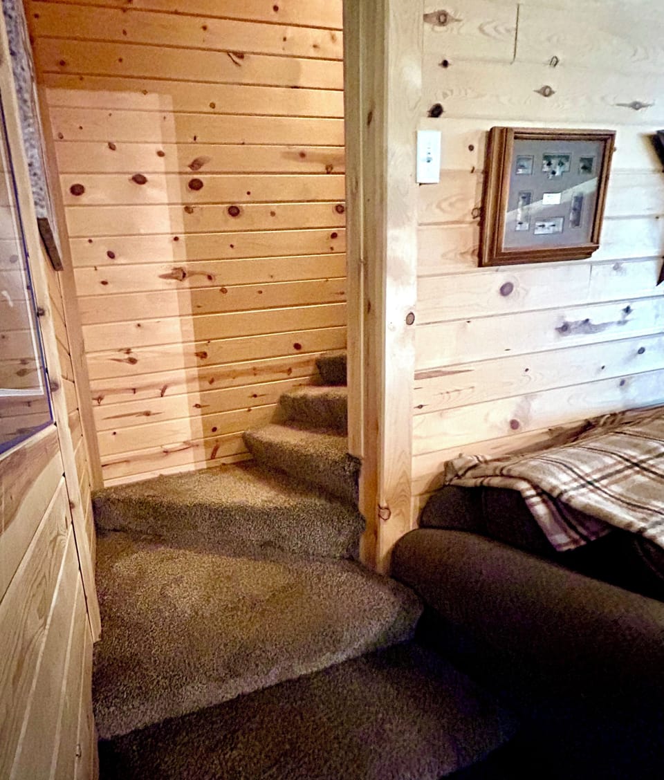 Stairs leading to three private bedrooms and an additional full bathroom. 