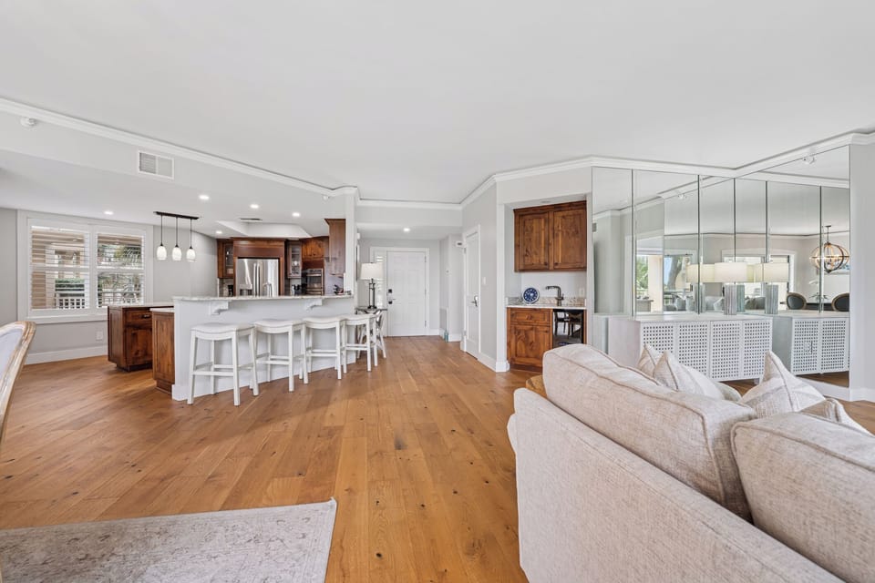 The space flows effortlessly into the dining area and kitchen, making it ideal for gathering after a day at the beach or enjoying easy evenings in.