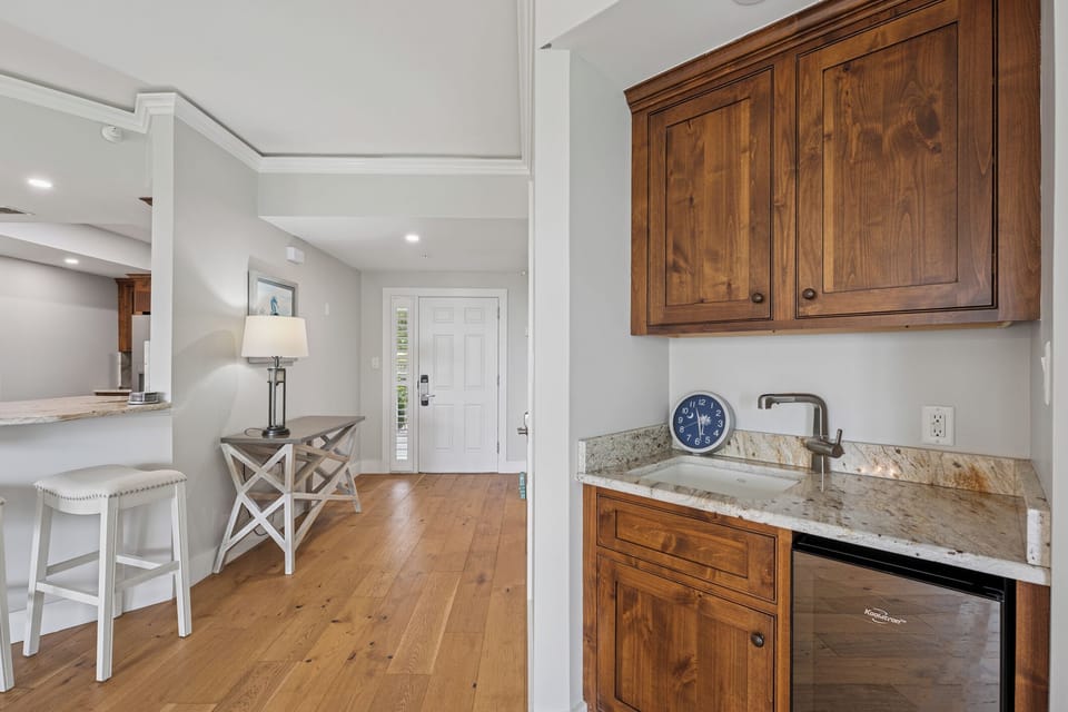 Warm and welcoming entry with a stylish bar nook and natural wood accents