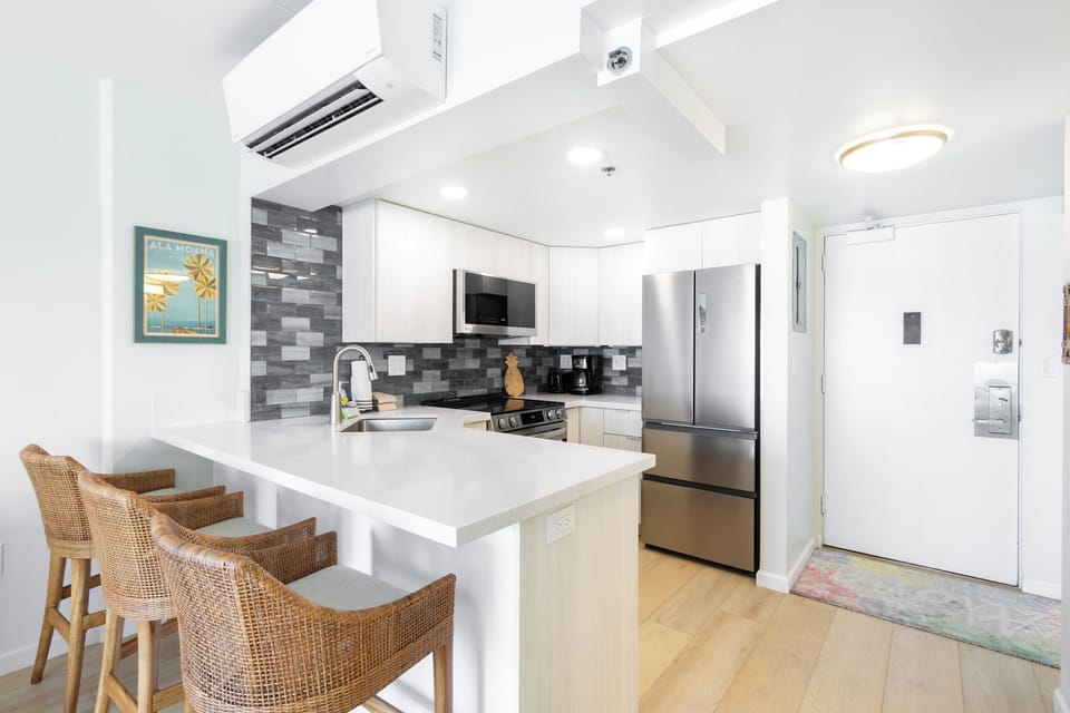 Cozy up to the bar in this chic, thoughtfully designed open kitchen