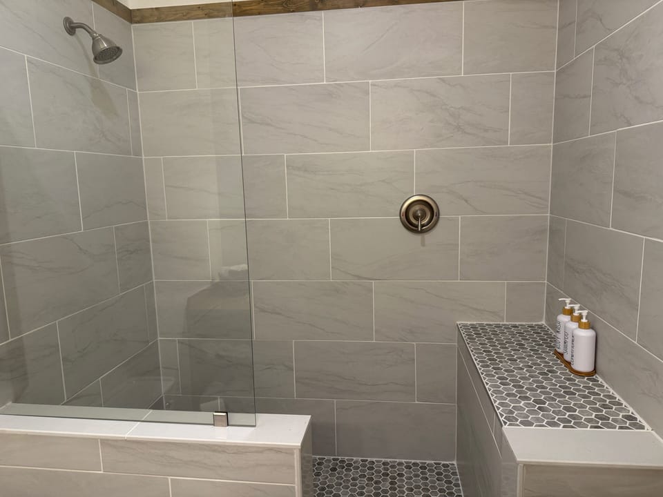 Shower with hair and body wash products.