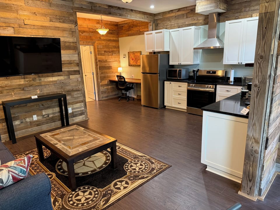 Open space with kitchen, living, desk, and dining.