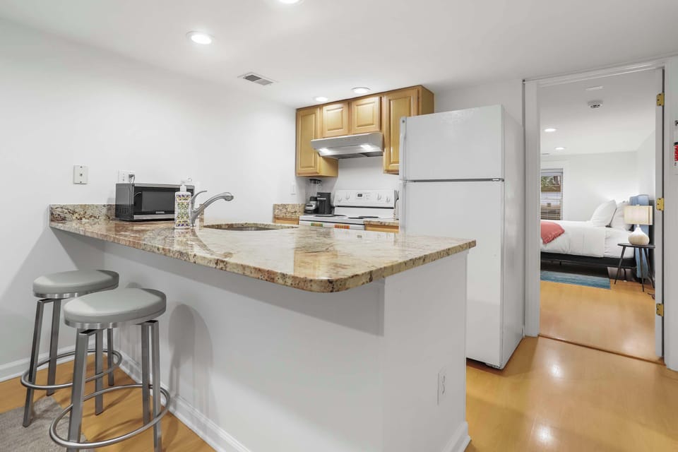 Kitchen with a view of the bedroom behind. 