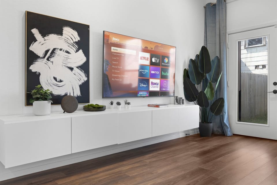 Living Room Oasis: Modern decor, smart TV, and natural light create a vibrant retreat!