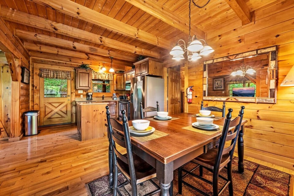 With the kitchen just steps away and the living room in view, this open dining area becomes the heart of the cabin—where meals, laughter, and conversation all come together.