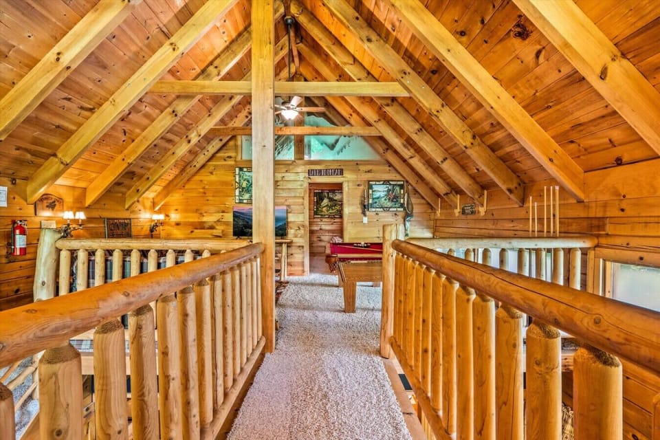 The open loft with cathedral ceilings and log railings offers a true Smoky Mountain cabin feel while giving you a space to relax and play.
