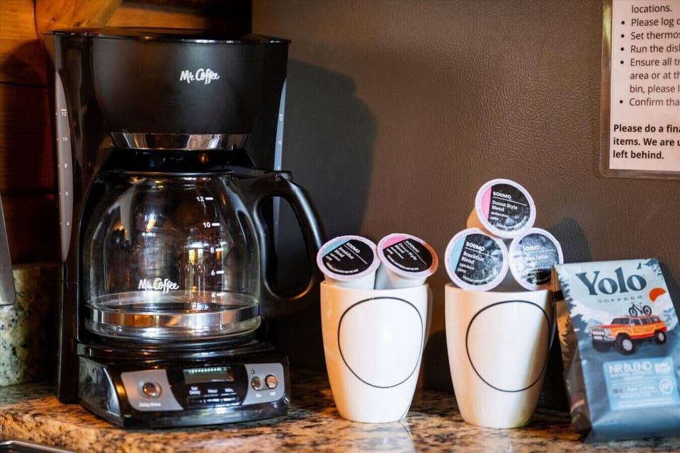 Coffee lovers will appreciate the convenient coffee station, complete with a drip coffee maker, mugs, and a selection of brews to start mornings right.