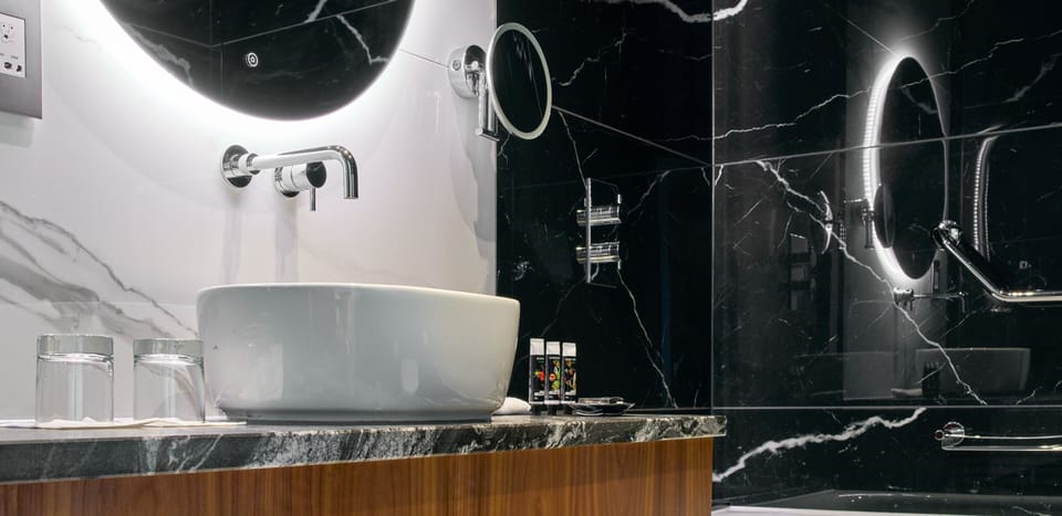 Combined shower/tub, designer toiletries, hair dryer, bathrobes