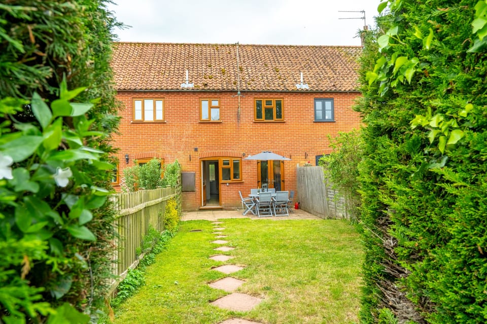 The garden leads to the rear entrance door
