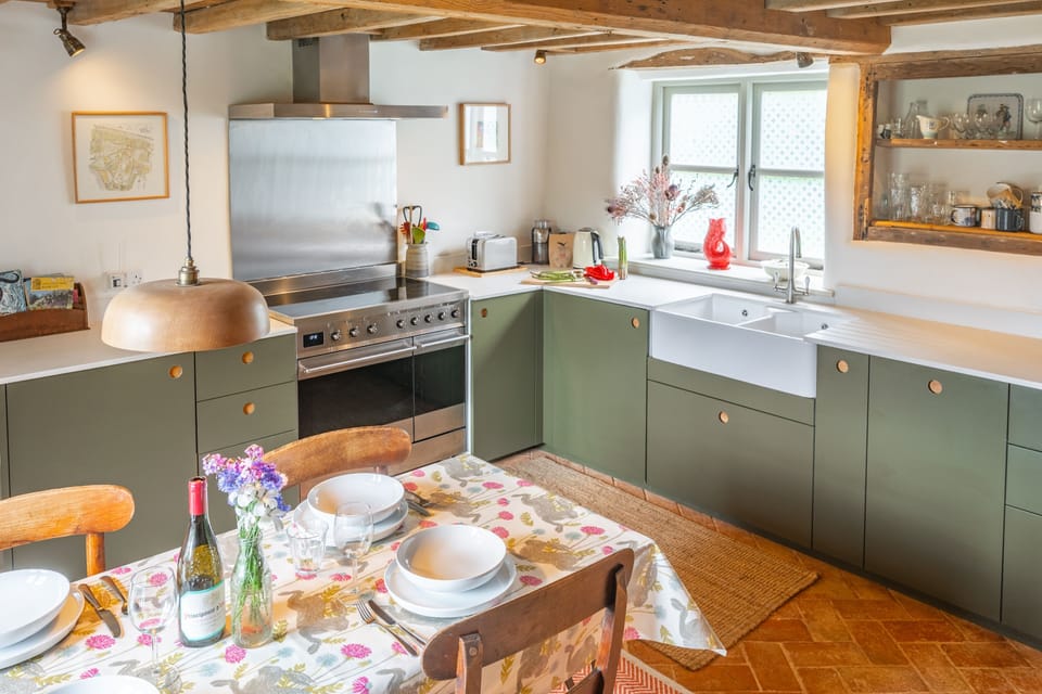 Ground floor: Kitchen/diner with range cooker, fridge with icebox, dishwasher and wine cooler, table with seating for six guests and breakfast bar with two stools